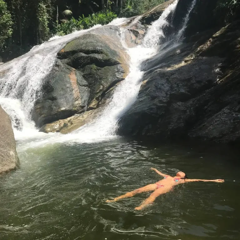 Pessoa boiando no poço de uma cachoeira na Flor de Maria